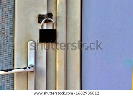 padlock on door of closed store Royalty-Free Stock Photo #1682936812