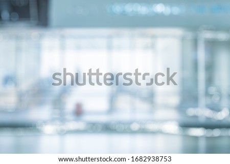 BLURRED OFFICE BACKGROUND, MODERN BUSINESS HALL WITH LIGHT REFLECTONS ON THE FLOOR