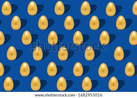 Flat lay pattern with gold eggs on dark blue backdrop. Creative minimal art. Holiday, easter background. Happy easter.