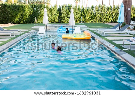 Kids Playing in Swimming Pool Royalty-Free Stock Photo #1682961031