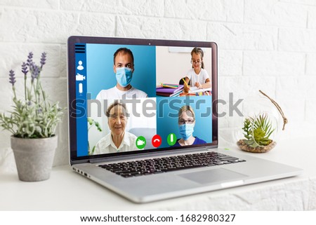Cropped image of young woman using laptop for video conference at home