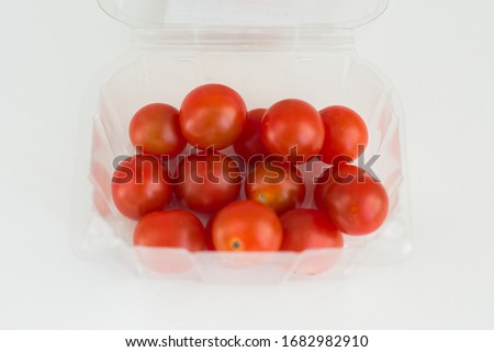 Fresh ripe cherry tomatoes close-up on white background top view. A delicious and healthy ingredient for sauces, ketchup, pizza, and vegetarians