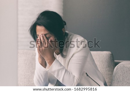 Coronavirus COVID-19 impact on retail businesses shut down causing unemployment financial distress. Depressed crying business woman stressed with headache. Royalty-Free Stock Photo #1682995816