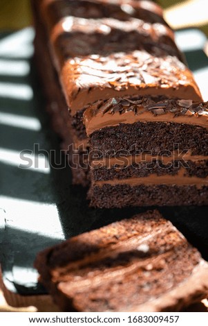 Chocolate cake on a black stone with delicious cacao cream