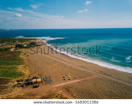 A sandy beach next to a body of water