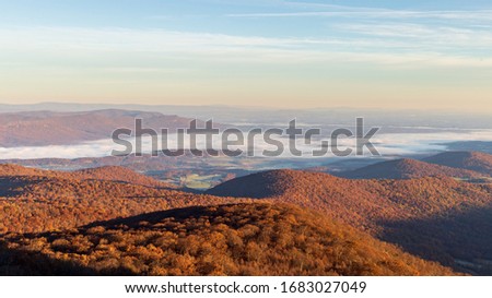 Fog lower in the valley near Shenandoah National Park during the peak of autumn's foliage