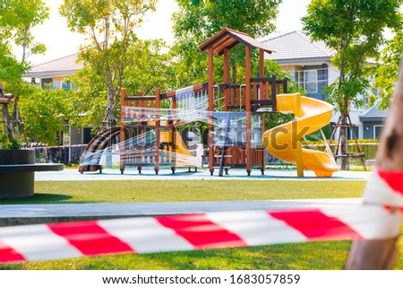 do not cross of a red white line in front of Rope blocking the boundary. No entry. Playground equipment To prevent the spread of the disease Coronavirus,Covid-19.shallow focus effect.