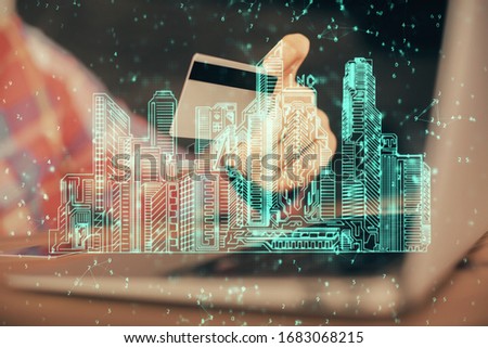 Double exposure of man hands holding a credit card and city drawing. modern town and E-commerce pay on-line concept.