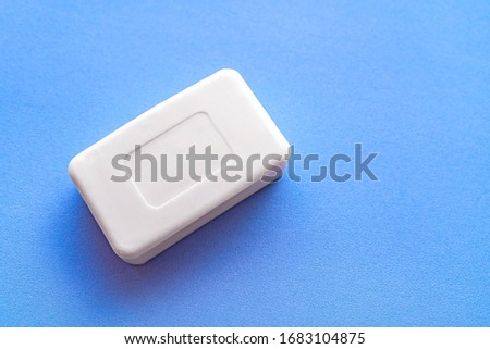 Soap for hand washing. A bar of soap in close - up isolated on a blue background. Space for text.