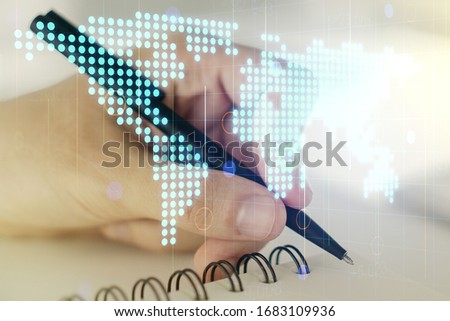 Multi exposure of abstract creative digital world map and man hand writing in notebook on background, tourism and traveling concept