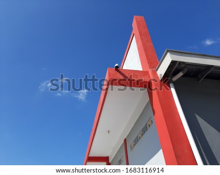 the roof of the building is painted red and white