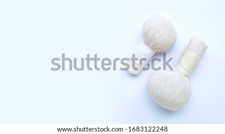 Herbal compress balls for Thai massage and spa treatment  on blue background.  Copy space Royalty-Free Stock Photo #1683122248