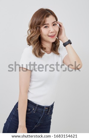 Cheerful Asain girl. A White T-Shirt with jeans. copy space for text.  Color bright gray background. A Sweet smile.