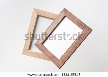 Design concept - top view of two brown wood photo frame float on mid air and isolated on white background for mockup, it's real photo, not 3D render