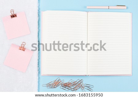 flat lay stationery on work desk in blue pastel background 