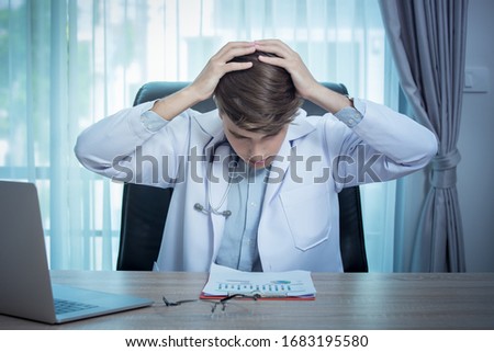 Male doctor working on desk with clipboard and serious on desk in office isolated on office background with copy space working in clinic or hospital medicine, healthcare concept for Covid19.
