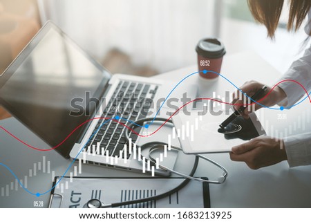 Doctor working monograph covid 19 and Laptop,Stethoscope with clipboard on white desk,Interior The hospital blurred background.- Image