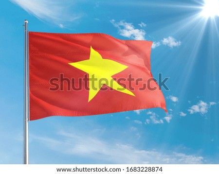Vietnam national flag waving in the wind against deep blue sky. High quality fabric. International relations concept.