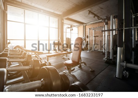 Blur Gym background concept with workout weight equipment in Fitness