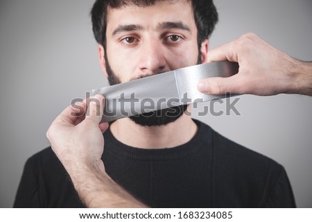 Caucasian man with tape on mouth. Censorship Royalty-Free Stock Photo #1683234085