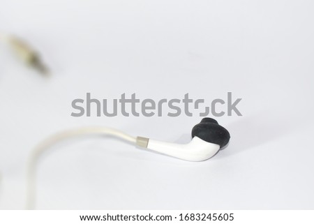Headphones (or head-phones in the early days of telephony and radio) traditionally refer to a pair of small loudspeaker drivers worn on or around the head over a user's ears.