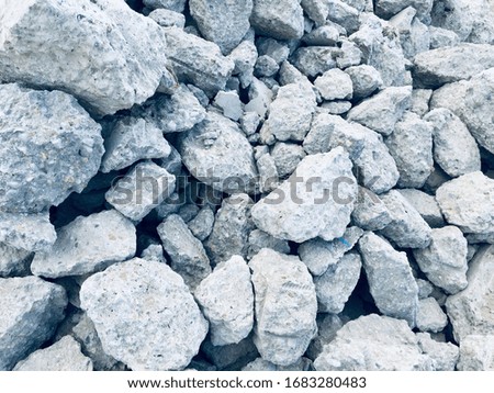 Background of boulder stones, gray cobblestones during construction, destroyed stones, stone abstract background and texture