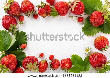 Frame made of fresh ripe strawberry berries on white background. Top view. Copy space. Flat lay. Food background.