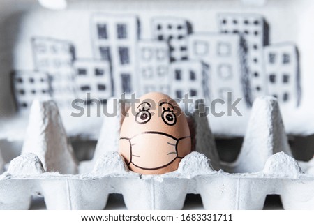 Chicken egg in a tray with doodle face wearing medical mask, city skyline on background. Conceptual image of social distancing and stay at home