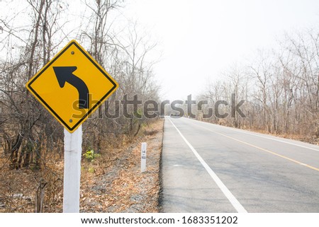 Traffic sign and Asphalt road in Autumn forest