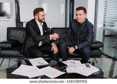 Two business partners handshake at group meeting making online project investment