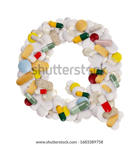 Capital letter Q made of various colorful pills, capsules and tablets on isolated white background