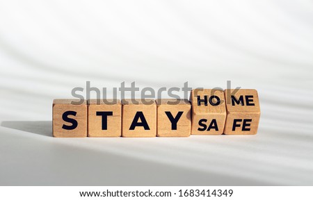 Stay at home stay safe message on wooden  blocks. Coronavirus COVID-19 outbreak advice Royalty-Free Stock Photo #1683414349