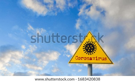 Coronavirus symbol on a yellow warning road sign. covid-19 Danger virus biohazard quarantine