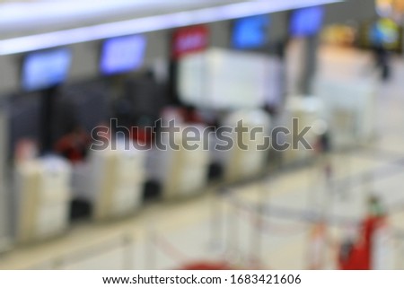 Abstract Blur Background : People walking in the terminal at Airport Check-In Counters With Passengers some one arrival some in their trip. no more people with bokeh during covid 19 virus.