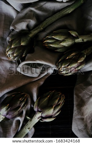 
wonderful bunch of artichokes to be sold. carciofi su sfondo grigio. fiore di carciofo biologico fresco