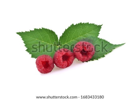 Raspberry with leaves isolated on white background.