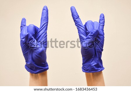 Hand in rubber gloves, protect from virus
