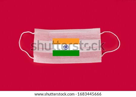 India flag.PANDEMIA.Medical mask, Medical protective mask on red background. Disposable surgical face mask cover the mouth and nose. Healthcare and medical concept.
