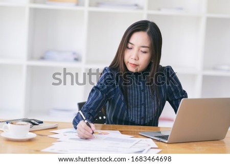 Portrait of a young business woman using laptop computer while working. Young asian business woman working with laptop in coffee shop cafe.