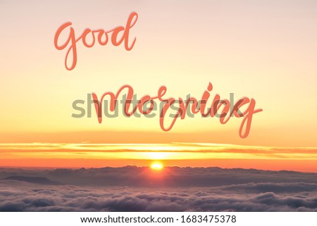 Nature background with sunrise over clouds and Good morning hand lettering text