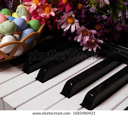 Colorful Paschal Easter Eggs and Piano Keys and Flowers