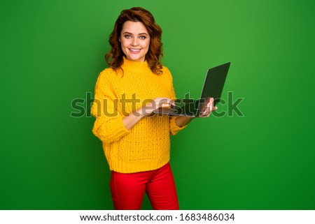 Profile photo of cheerful business lady hold notebook hands browsing freelance IT website administrator wear yellow knitted pullover red pants isolated green color background