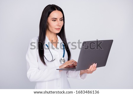 Photo of beautiful professional doc lady watch modern technology notebook novelty innovation medical reform wear stethoscope white lab coat isolated grey color background