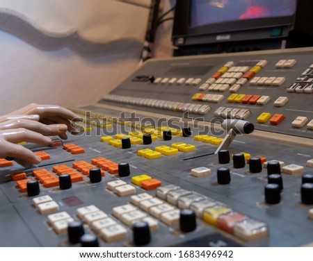 Professional broadcast video switcher. Live television productions, shallow depth of field. Selective focus. Vintage.