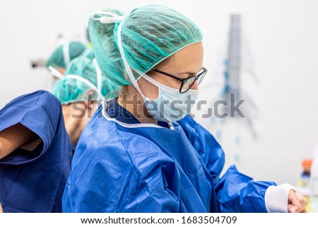 Covid-19. Female nurse puts on protective gloves. Personal protective equipment in the fight against Coronavirus disease . Royalty-Free Stock Photo #1683504709