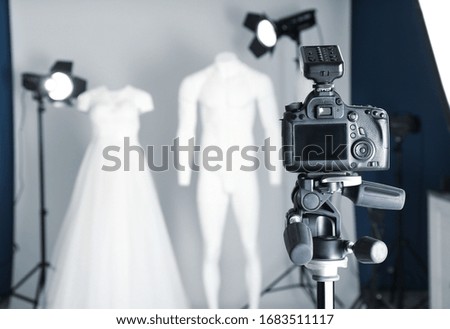 Taking pictures of ghost mannequins with modern clothes in professional photo studio, focus on camera