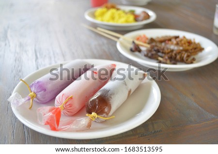 Assorted iced syrup wrapped in plastic tube, served as dessert in traditional javanese restaurant. Royalty-Free Stock Photo #1683513595