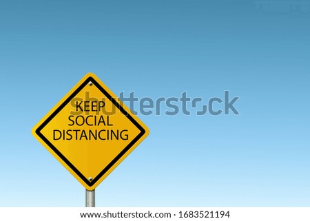 Social Distancing warning sign, Warning in a yellow sign about coronavirus or Covid-19  