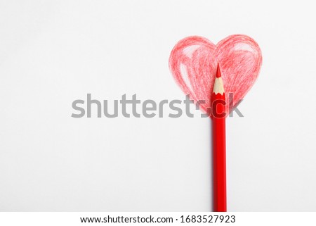 Drawing of heart and red pencil on white background, top view