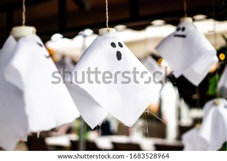 Hanged cute and simple ghost puppet made from white cloth.